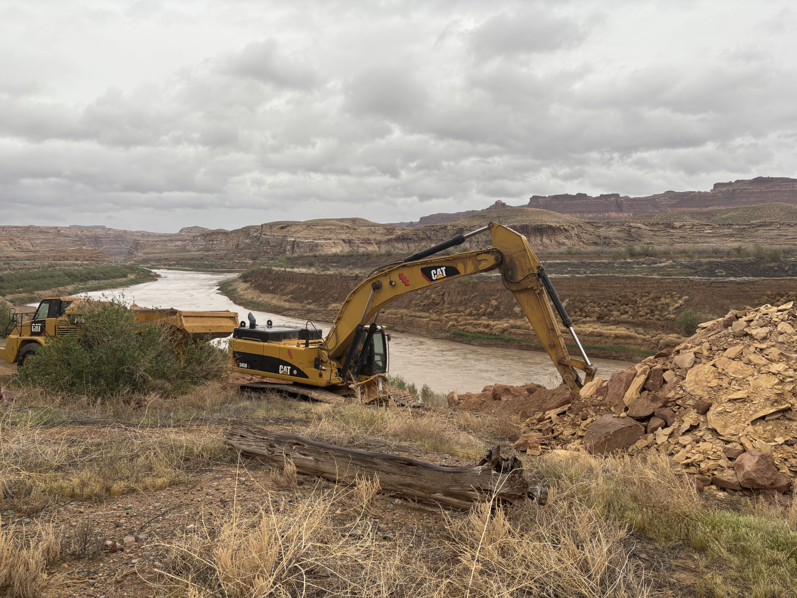 Heavy equipment digging dirt for boat ramp construction
